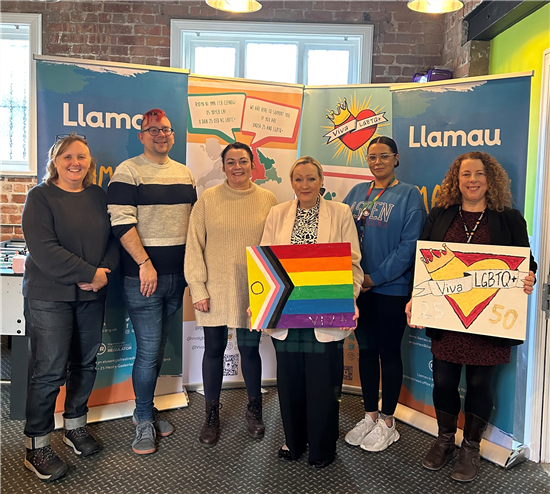 6 people standing in front of banners